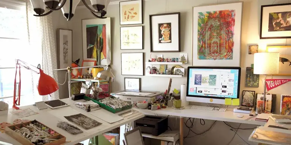 A designer's desk with art prints and swatches