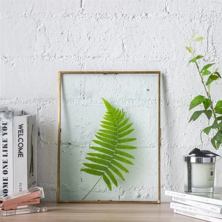 A cozy corner with a framed poster and a plant